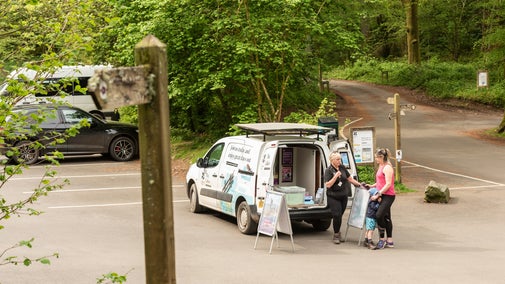 Mother and son speaking to the welcome team at Great Wood car park
